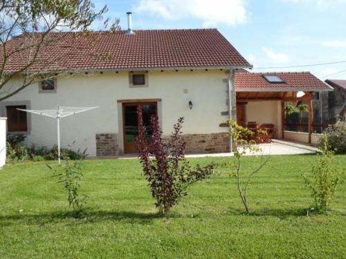 a house with a green yard with a house at Gîte spacieux avec terrasse, confort moderne dans un cadre verdoyant et propice aux balades. - FR-1-589-79 in Bains-les-Bains