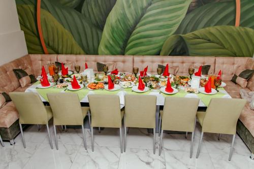 a table with plates of food and red hats on it at Гостинний двір "Марія" in Kropyvnytskyi