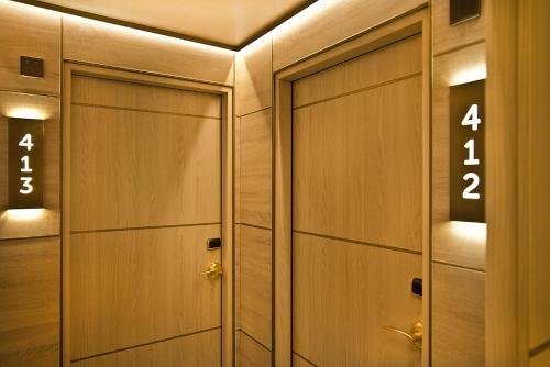 a row of wooden lockers with numbers on them at Preciados in Madrid