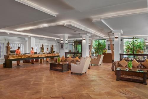a lobby of a hotel with couches and tables at Palace Gate Hotel & Resort by EHM in Phnom Penh