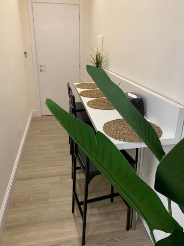 a room with a table with plants on it at Pompei Luxury Suite in Pompei