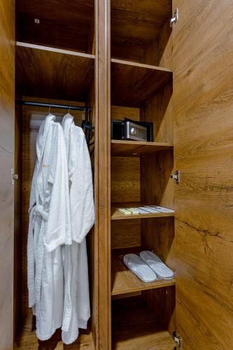 a closet filled with white robes and towels at Monument1880 in Tbilisi City