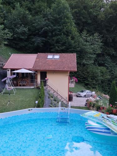 a large swimming pool in front of a house at Farm ,zidanica ,JOLI in Gorica pri Slivnici