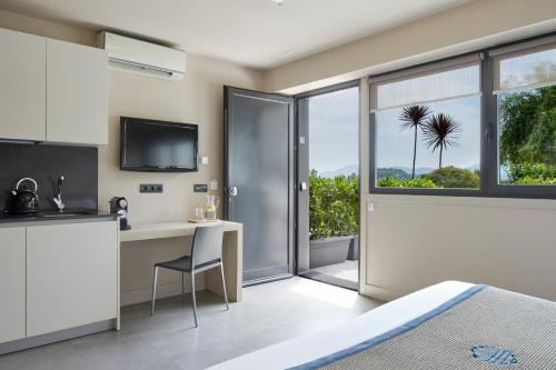 a bedroom with a bed and a desk and a window at FeelFree STAYS Basoa in Donostia-San Sebastián