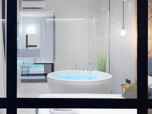 ein weißes Bad mit einer Badewanne in einem Zimmer in der Unterkunft 5 star lux suite in Kolonaki. in Athen