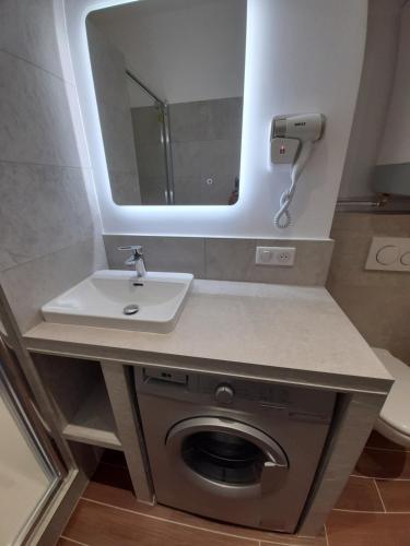 a bathroom with a sink and a mirror at BRILOC AJACCIO centre ville in Ajaccio