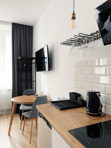 a kitchen with a table with chairs and a dining room at BOOGIE Home Kamienica Łódzka in Łódź