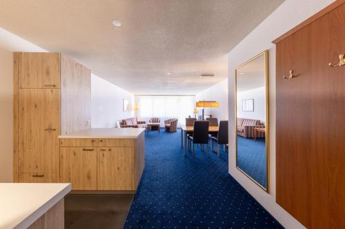a room with a kitchen and a dining room at Apart Holidays in Morschach
