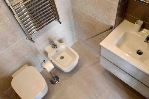 a bathroom with a toilet and a sink at Chiara Home Sorrento in Sorrento