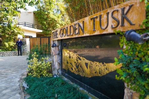 a sign that says the golden trust in front of a building at The Golden Tusk By Ivory Destinations in Rāmnagar