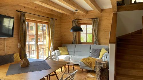 a living room with a couch and a table at Mankerl Hütte Lachtal in Lachtal