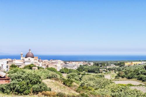 a view of a city with the ocean in the background at La casa di Lo, marina di Sorso in Sorso