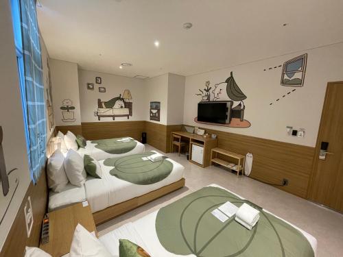 Habitación de hotel con 2 camas y TV en Sangsang Stay Busan en Busan