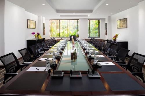 a large conference room with a long table with chairs at Palace Gate Hotel & Resort By EHM in Phnom Penh
