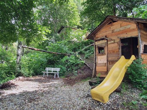 a playground with a slide and a wooden shed at Forest Lodge in Bayerisch Eisenstein