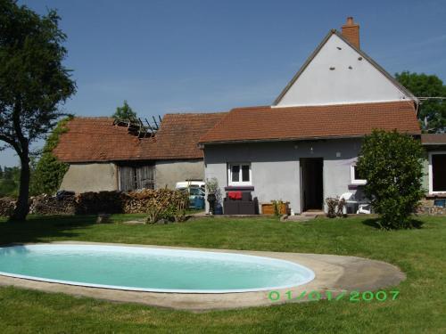 a house and a swimming pool in front of a house at chez gourbeix in Arpheuilles-Saint-Priest