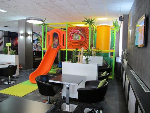 a playroom with a slide and a playground at Hotel Kapitol in Most