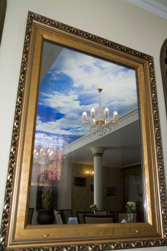 a mirror with a reflection of a dining room at Dworek Jolanta in Biała Podlaska