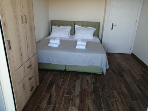 a bedroom with a bed with two towels on it at KOTSERIS LUXURY VILLAS, Jiovanni Villa & Angelina Villa in Sivota