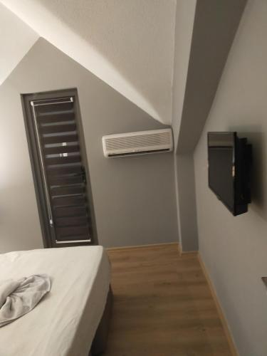 a bedroom with a bed and a air conditioner at Akdeniz apart hotel in Marmaris