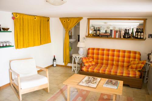 a living room with an orange couch and a table at Ostuni home nature in Ostuni
