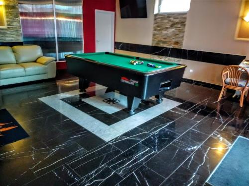 a pool table in a living room with a billiard at Hotel Zur Rose in Bad Karlshafen