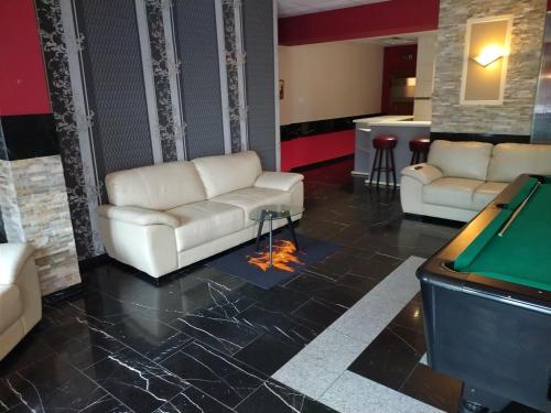a living room with couches and a pool table at Hotel Zur Rose in Bad Karlshafen