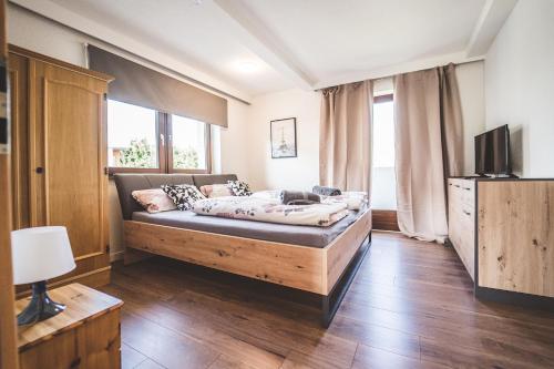 a bedroom with a bed and a large window at Casa Melissa in Schönberg im Stubaital