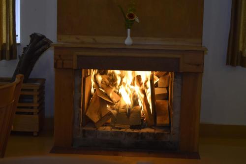 a fire in a fireplace in a room at Altius Nest Hotel in Kodaikānāl