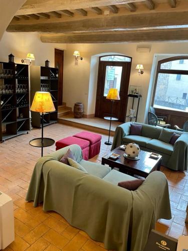 a large living room with couches and a table at la locanda di anita in Cetona