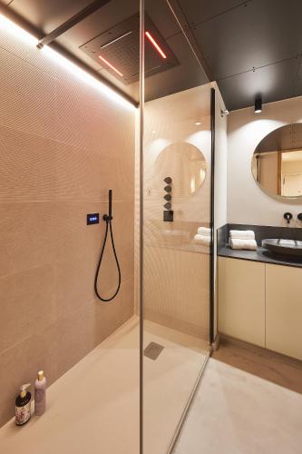 a shower with a glass door in a bathroom at Vip House Ainsa in Aínsa