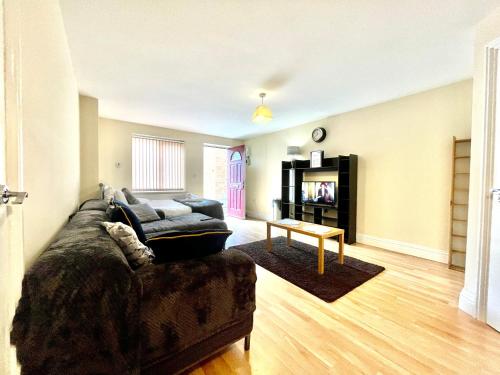 a living room with a couch and a table at Lt Properties Studio apartment Ground floor 3 in Luton