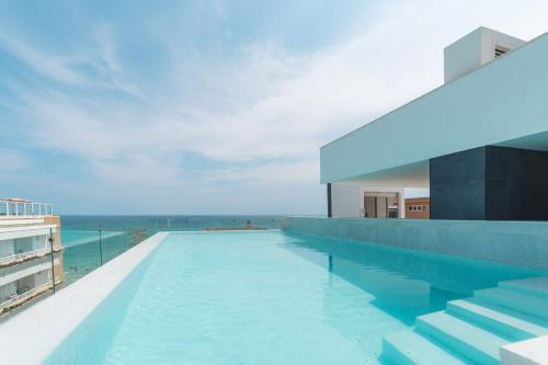 a swimming pool with a view of the ocean at Senator Cala Millor in Cala Millor