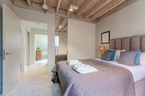 a bedroom with a large bed with towels on it at StayInn Holborn in London