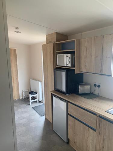 a kitchen with a counter top with a microwave at Seton Sands Haven Holiday Village in Edinburgh