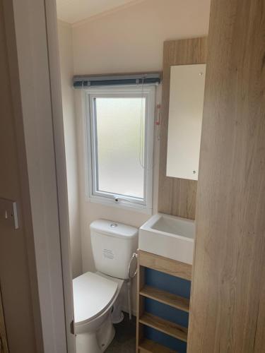 a small bathroom with a toilet and a sink at Seton Sands Haven Holiday Village in Edinburgh
