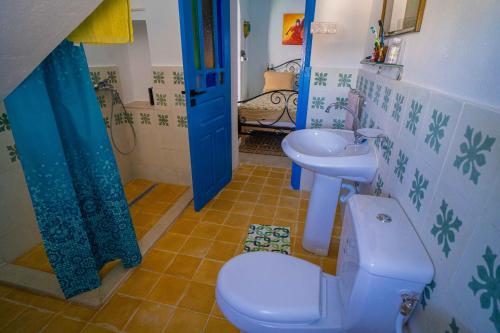 a bathroom with a toilet and a sink at Dar Aida Zaghouan in Zaghouan