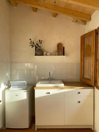 a kitchen with white cabinets and a sink at El Rincón de El Montán in Avilés