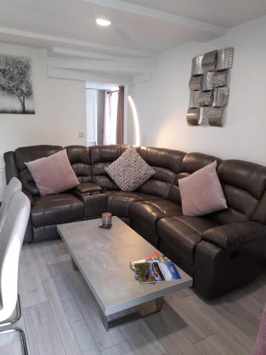 a brown leather couch in a living room with a coffee table at Doonan Breeze in Donegal