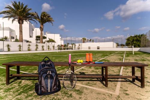a backpack sitting on a picnic table with a backpack at Hotel Lanzarote Village in Puerto del Carmen