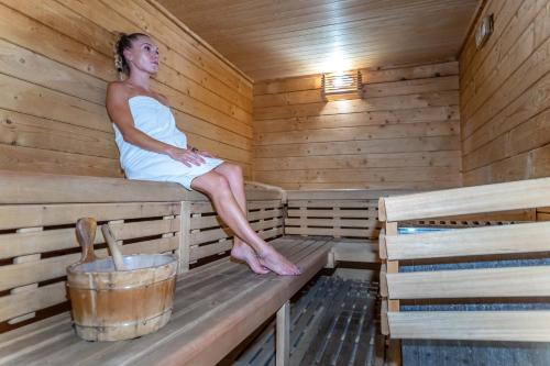a woman sitting in the inside of a sauna at Hotel Lanzarote Village in Puerto del Carmen