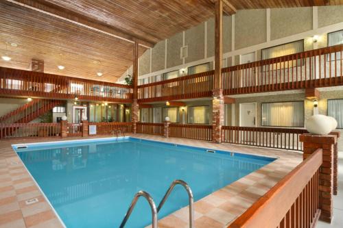 a large pool in a hotel with a building at Days Inn by Wyndham Vernon in Vernon