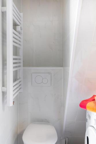 a white bathroom with a toilet and a sink at Trendy studios Tassin in Tassin-la-Demi-Lune