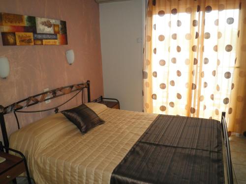 a bedroom with a bed with a pillow on it at Babis in Skiathos Town