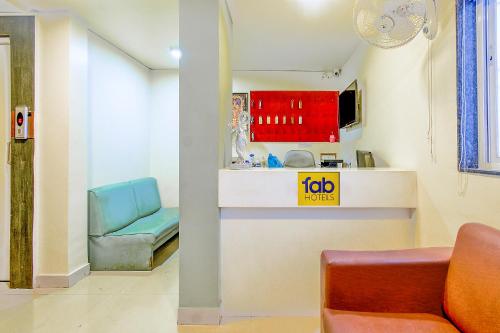 a living room with a couch and a chair at FabHotel Nandanvan in Pune