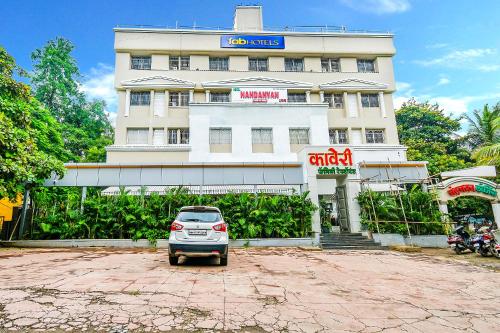 a car parked in front of a building at FabHotel Nandanvan in Pune