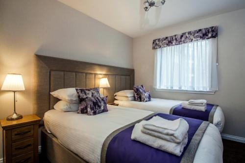 a bedroom with two beds and a window at The Knight Residence by Mansley in Edinburgh