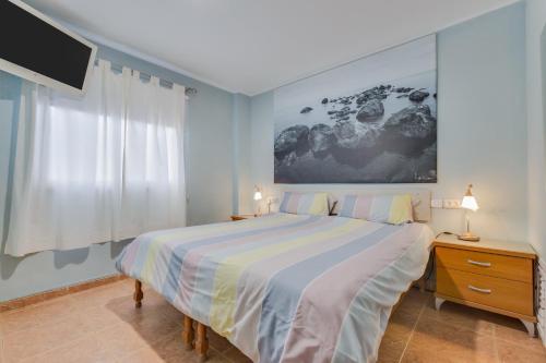 a bedroom with a large bed and a tv at Apartamento Deluxe in Candelaria