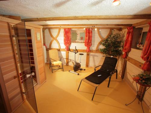 a room with chairs and a window with red curtains at Haus Gehmacher-Maier - Chiemgau Karte in Inzell