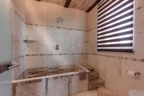 a bathroom with a shower with a sink and a window at Be Vedetta - Relais & Glamping - Adult Only in Scarlino